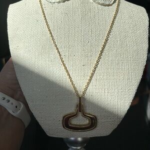 Kramer gold necklace with pendant.